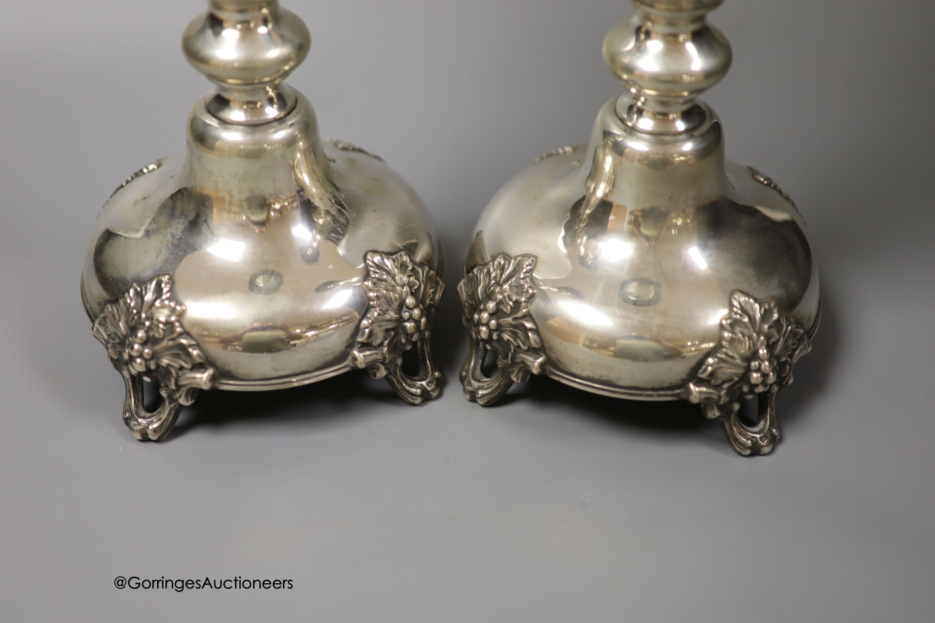 A pair of 19th century Polish? white metal candlesticks, 33.1cm, weighted